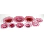 Nine hand blown cranberry glass dishes, 3 large approx 20cmD, the others 12-14cmD