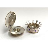 A Design House Stockholm silver plated lidded tealight holder; together with a plated crown candle