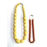 A bakelite style bead necklace, approx. 139g, the largest bead 3cmL, 58cmL; together with an amber