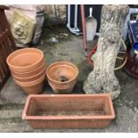 A quantity of terracotta pots, together with a composite stone garden feature, 65cmH