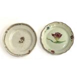 Two 18th century French faience plates, each with floral design, one a tulip, each 23cmD