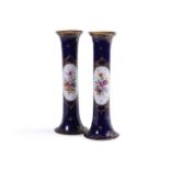 A pair of Dresden porcelain blue ground and gilt cylindrical vases, c.1900, each painted with a