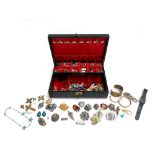 A jewellery box containing a quantity of costume jewellery and enamel badges; to include Miracle,