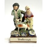 A late 18th early 19th century Staffordshire figure group of a couple and a sheep (af), the plinth