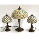 A Tiffany style table lamp, 58cmH; together with a pair of Tiffany style bedside lamps, each