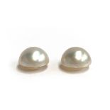 A matched pair of loose Mabe pearls, each approx. 1.8cmD