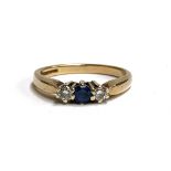A 9ct gold ring set with diamonds and a sapphire, size N, approx. 2.7g
