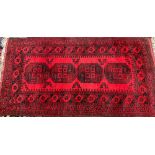 A small red ground Persian rug, 105x195cm