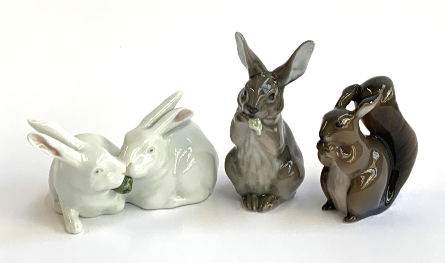 Three Royal Copenhagen figurines, pair of rabbits no. 518, rabbit eating no. 1019 and squirrel no.