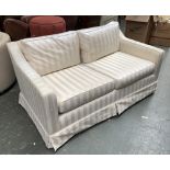 A two seater sofa in a striped cream fabric, 90cmD 152cmW