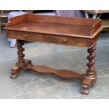 A Victorian mahogany writing desk, three quarter gallery, over two frieze drawers, on two spiral