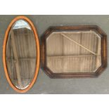 An oak framed wall mirror, with canted corners and bevelled glass, 73x58cm, together with one