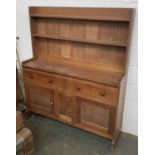 A Cotswold style oak dresser, two shelves above a base of two drawers and cupboards, 132x38x156cmH