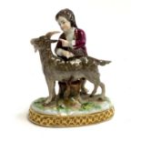 A Capodimonte figure of a boy and a goat, heightened in gilt, 12.5cmH