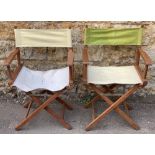 A pair of teak and canvas folding garden chairs