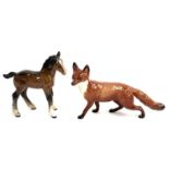 A Beswick fox figurine (af), 23cmL; together with a Beswick figure of a foal, 15cmH