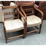 A matched pair of early 19th century oak open armchairs, with stuffover seats, together with two