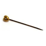 A small 15ct gold puffy heart stick pin set with a seed pearl, the pin steel, the heart 0.8cmW, appr