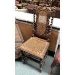 A Victorian oak and cane side chair, in Jacobethan taste, carved with a grape and vine decoration,