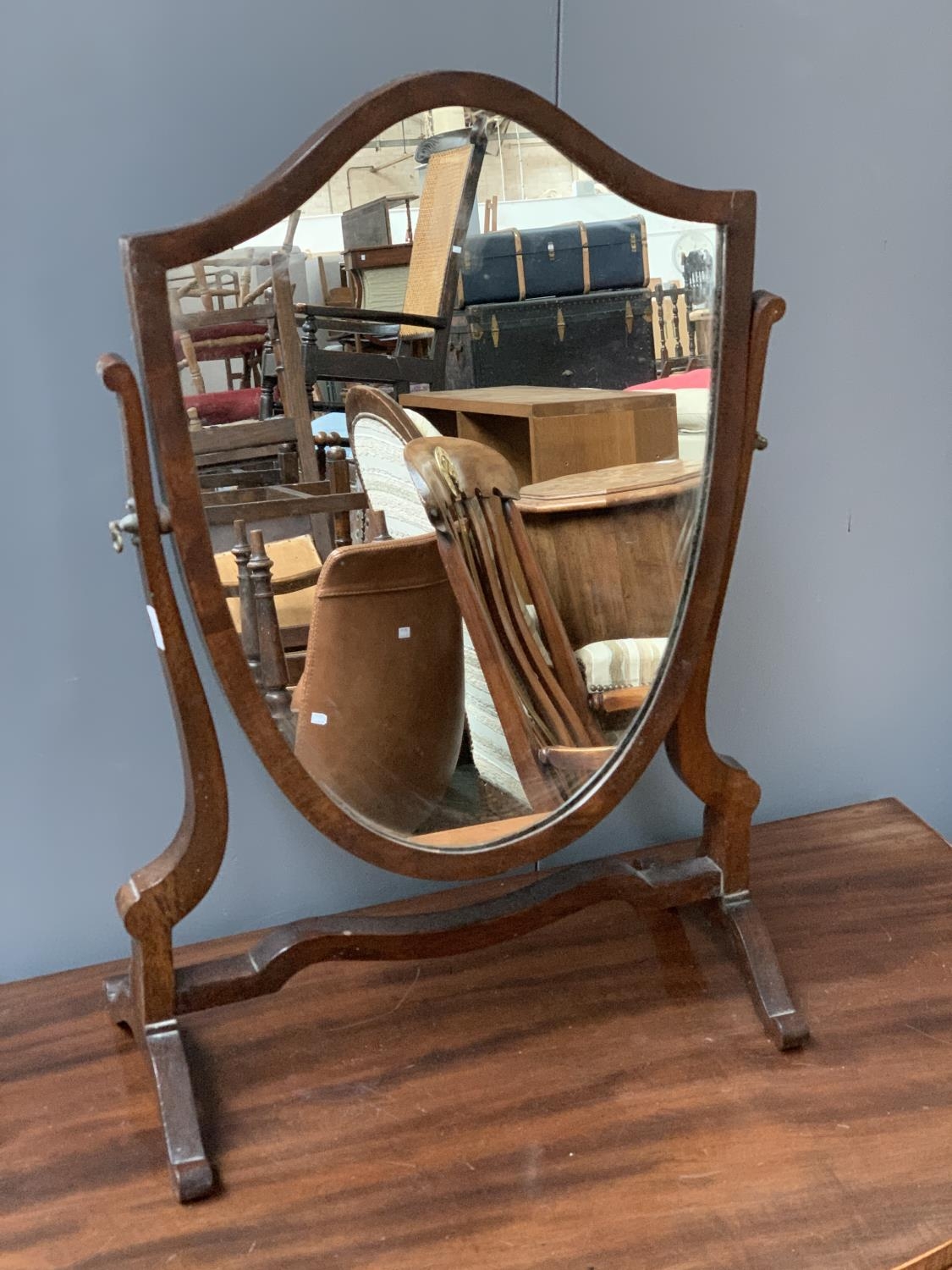 A 19th century shield shaped adjustable dressing mirror, 59cmH