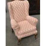 A wingback armchair on claw and ball feet, 77cmW