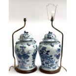 A large pair of decorative blue and white Chinese lidded urns, each on turned wood stand with gilt