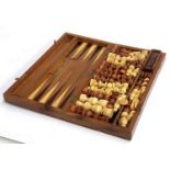 A cased burr wood chess/backgammon set with pieces