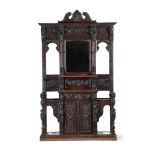 A carved oak hall stand in antiquarian taste late 19th or early 20th century with ivorine label to