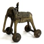 An Indian bronze temple toy in the form of an elephant and rider, raised on four wheels, 19cmH