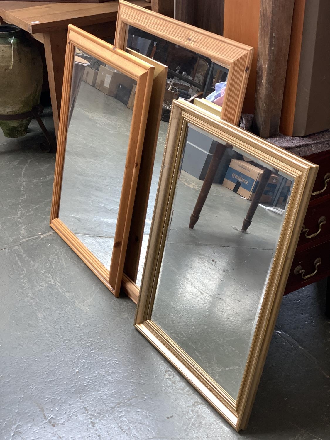 Two pine framed rectangular wall mirrors, 73x105cm and 64x90cm; together with one other modern