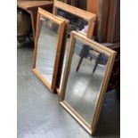 Two pine framed rectangular wall mirrors, 73x105cm and 64x90cm; together with one other modern