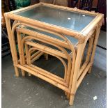 A nest of three bamboo glass topped tables, the largest 58x42x60cm