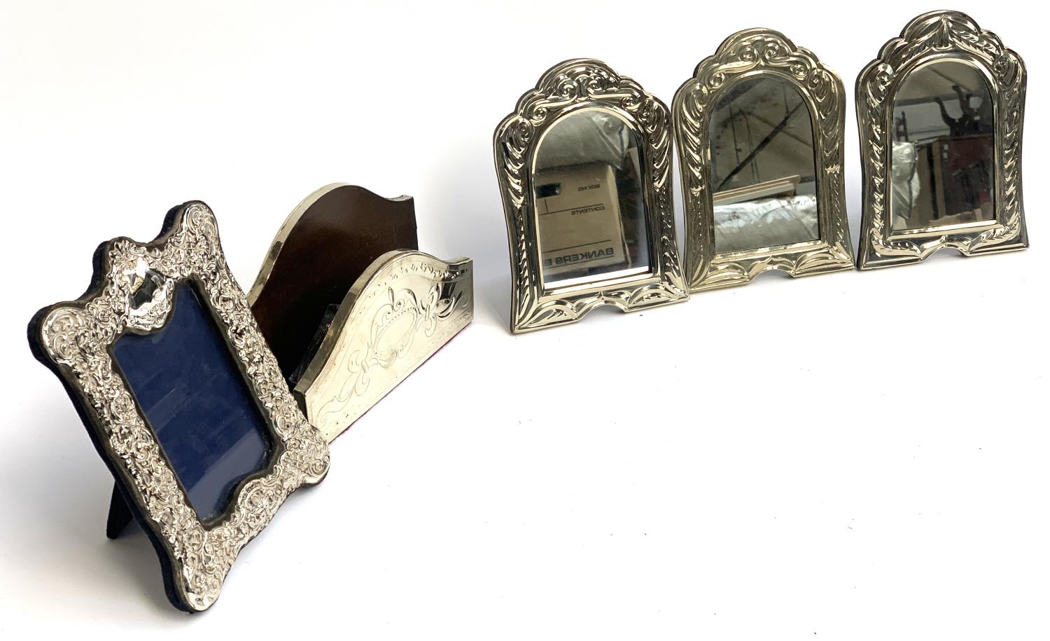 A set of three white metal mirrors, a chased metal picture frame and a letter rack