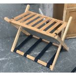 A folding bamboo luggage rack