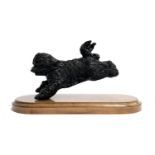 A cold cast figure of a leaping cockapoo on stand, 27cmW