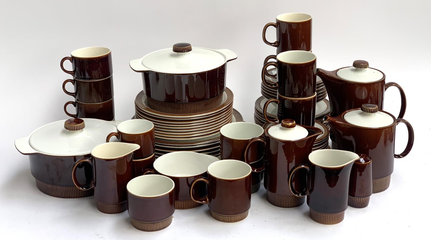 A Poole Pottery treacle glazed dinner service to include lidded tureen, teapot, coffee pot, dinner