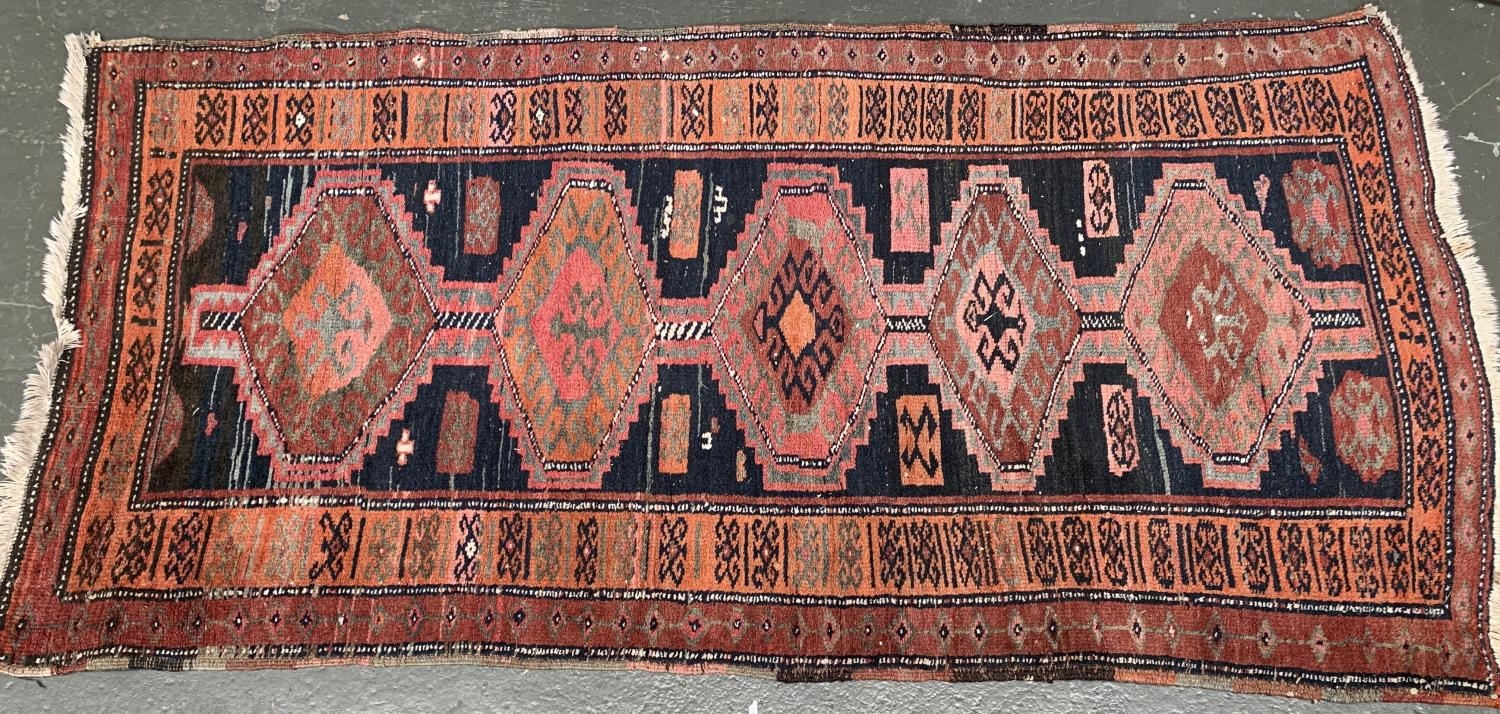 A West Persian rug with 5 serrated lozenges, 230x110cm