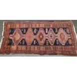 A West Persian rug with 5 serrated lozenges, 230x110cm