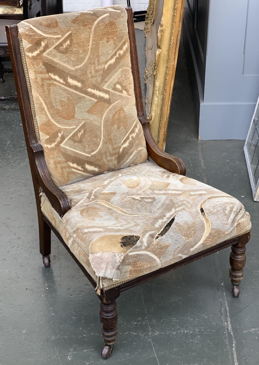 An oak framed Victorian nursing chair, on turned legs in need of reupholstering, the seat 62cmW