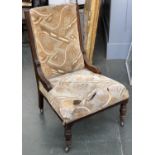 An oak framed Victorian nursing chair, on turned legs in need of reupholstering, the seat 62cmW