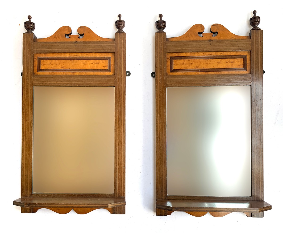 A pair of mahogany and burr maple wall mirrors with bevelled glass and shelf, each 56x29cm
