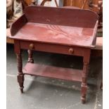 A 19th century painted pine wash stand, with three quarter gallery and blind drawer, on turned