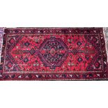 A small West Persian red ground rug, 95x185cm