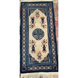 A small blue Chinese rug depicting vases, 160x75cm