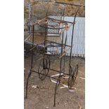 A three tier wrought iron pot stand