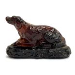 A 19th century pressed glass figure in the form of a recumbent dog, 15cmL