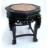 An octagonal Chinese black lacquered side octagonal table with marble inset top, 41x47cmH