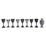 A set of eight Persian minakari enamel small stemmed cups, floral sprays on a black ground, each 9.
