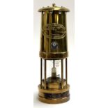 A brass miner's lamp by E Thomas & Williams Ltd, bearing applied enamel badge for Cardiff City FC