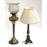 A brass oil lamp with reeded column and frosted shade, 61cmH to top of shade; together with a